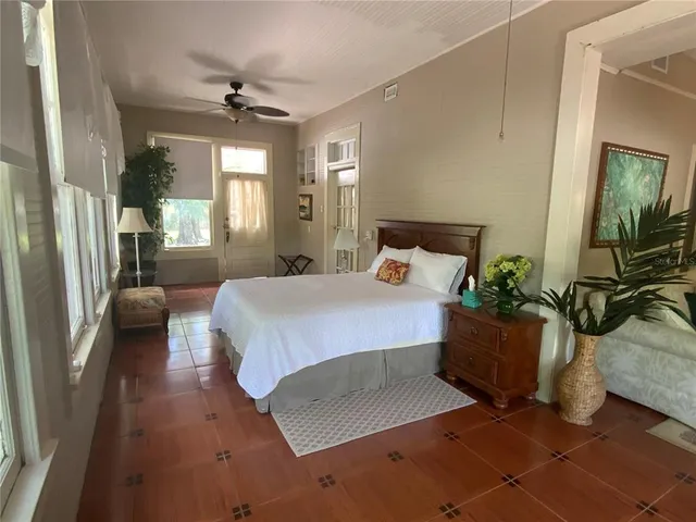 a bedroom with a bed a couch and dresser