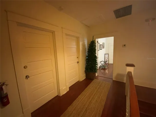 a view of hallway with wooden floor