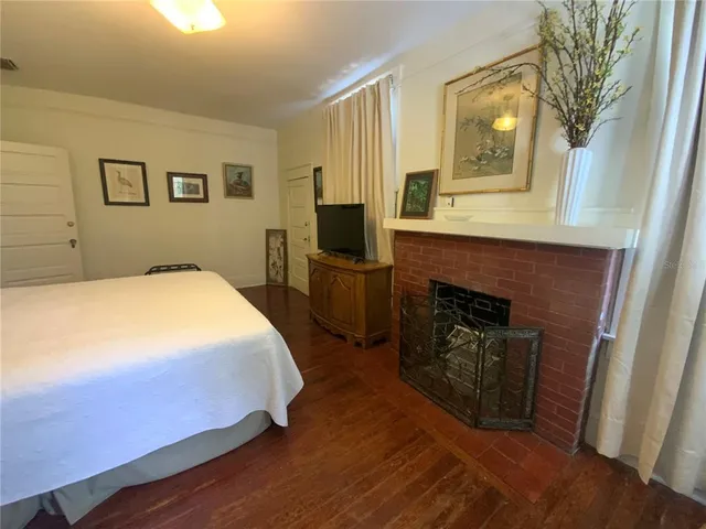 a bedroom with a bed and a fireplace