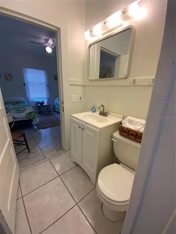 a bathroom with a toilet a sink and mirror
