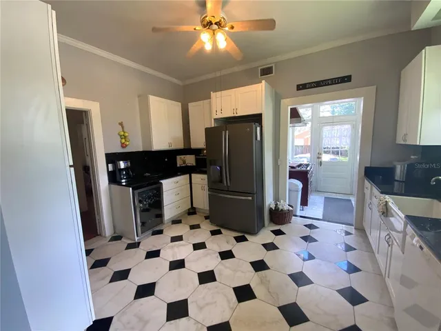 a kitchen with a checkered floor and a refrigerator