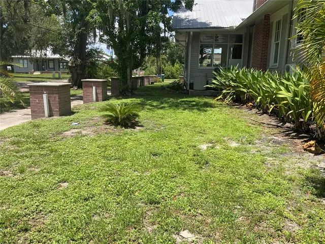 a front view of house with yard and trees