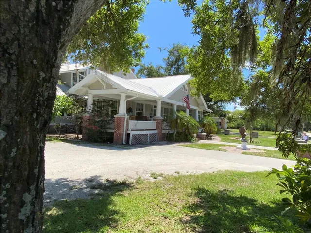 a view of a house with a yard and plants