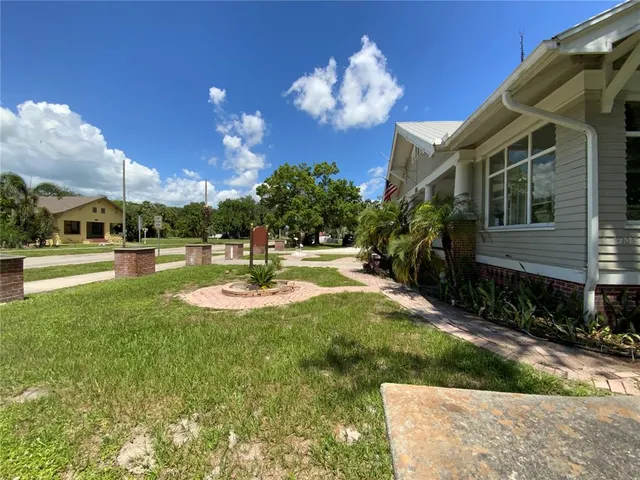 a view of a garden with a building in the background