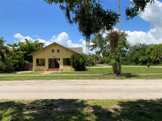 a house with a yard and a large trees