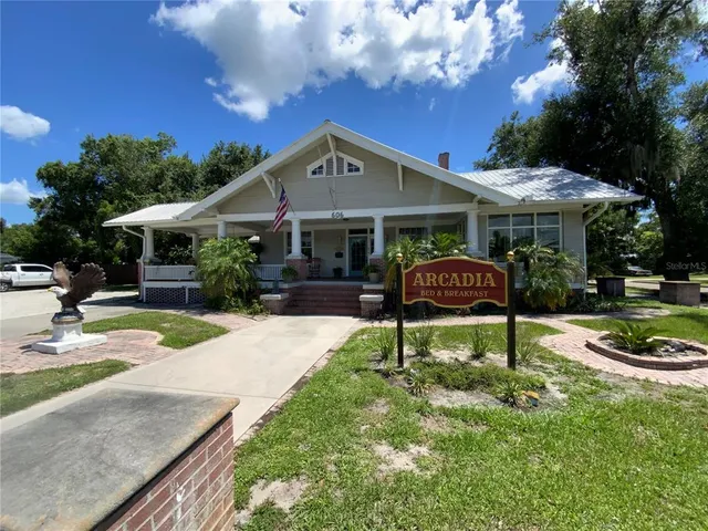 a front view of a house with garden yard and outdoor seating