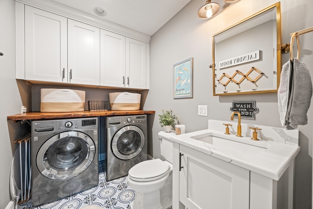 26 West Way Mashpee, MA 02649 - Photo 11 of 42 a bathroom with a sink a washer and dryer