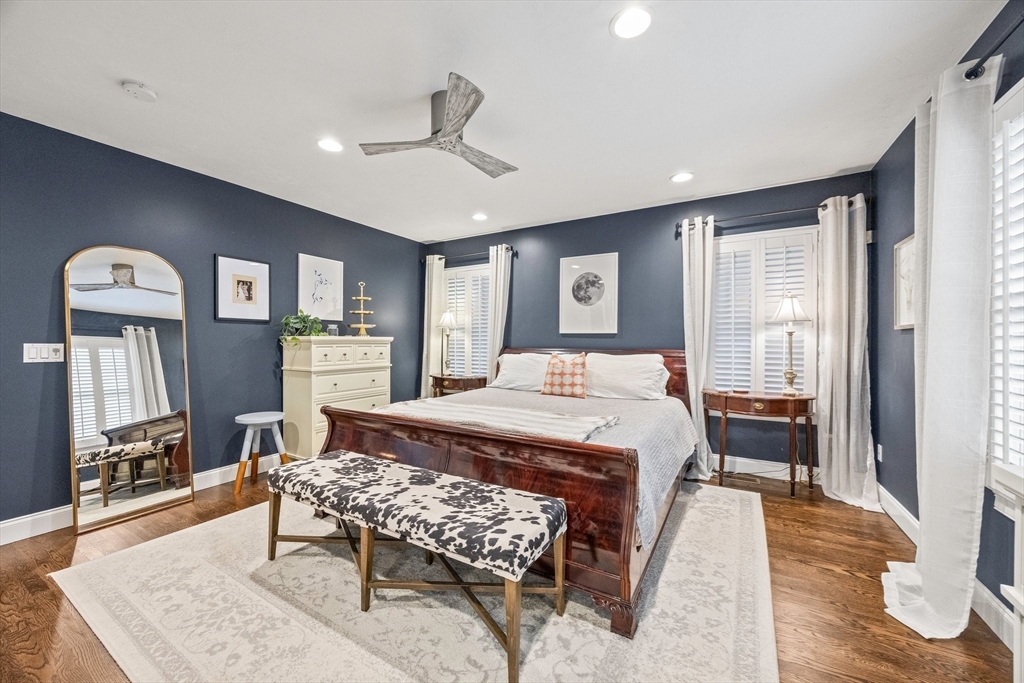 26 West Way Mashpee, MA 02649 - Photo 13 of 42 a bedroom with a bed a table and painting on the wall