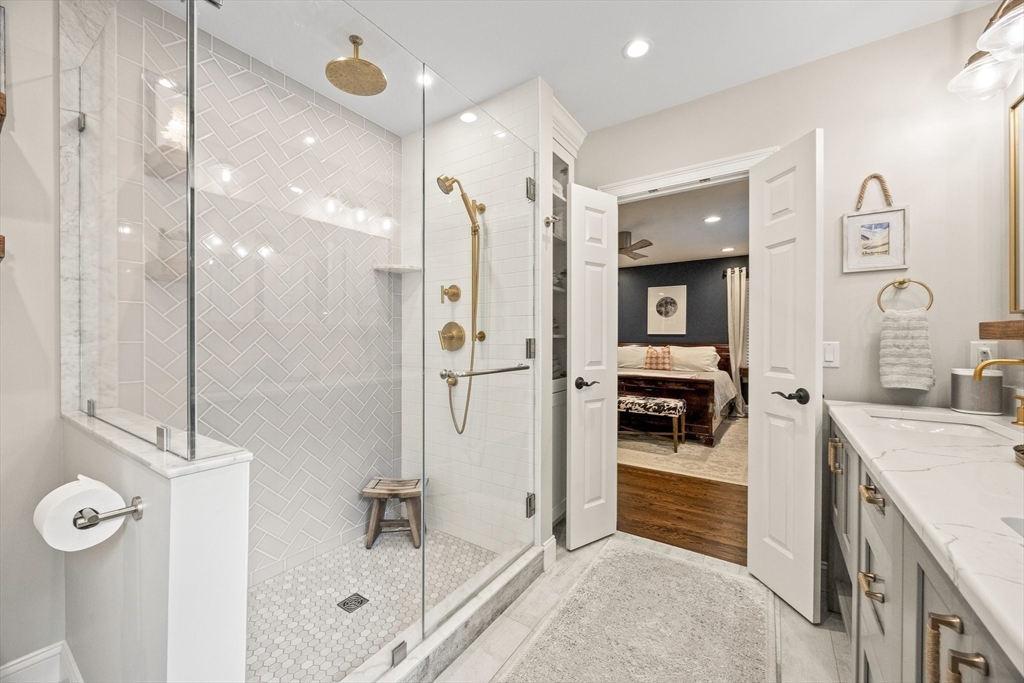 26 West Way Mashpee, MA 02649 - Photo 15 of 42 a bathroom with a tub sink shower and mirror