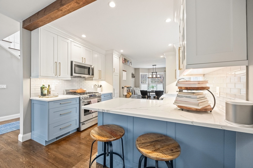26 West Way Mashpee, MA 02649 - Photo 19 of 42 a kitchen with stainless steel appliances a sink a stove a refrigerator cabinets and a window