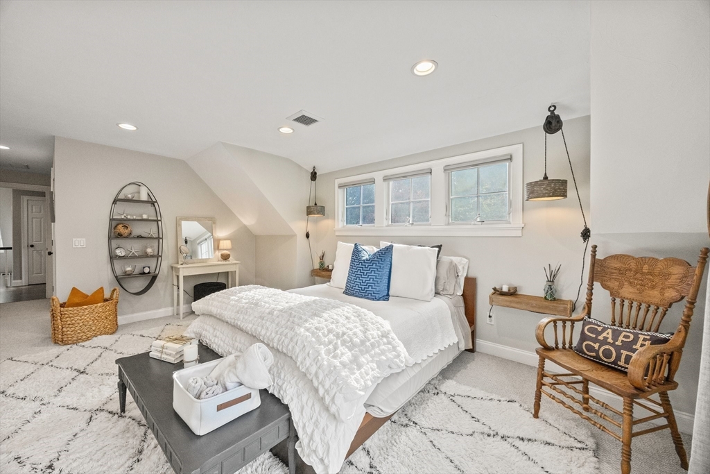 26 West Way Mashpee, MA 02649 - Photo 27 of 42 a bedroom with a bed and wooden floor