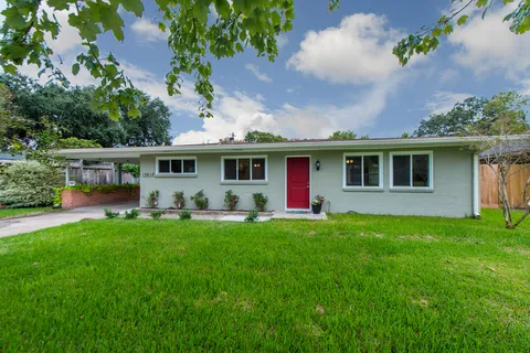 a front view of house with yard and green space