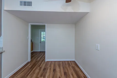a view of a hallway with wooden floor