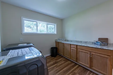 a hallway with a bed and window
