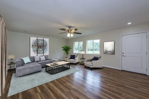 a living room with furniture and wooden floor
