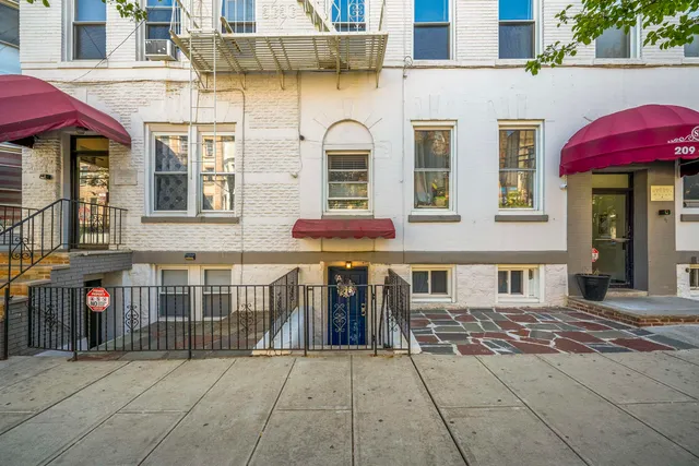 a view of a brick building with many windows