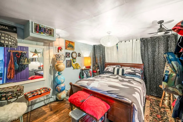 a backyard of a building with barbeque oven and plants