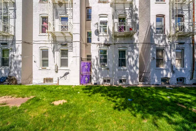 a view of a building with a yard