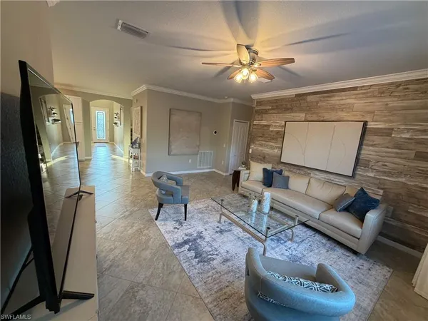 a living room with furniture and a chandelier