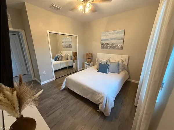 a bedroom with a bed couch and a window