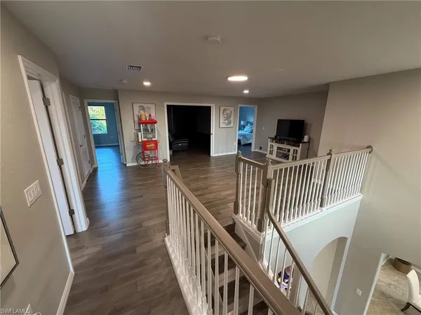 a view of a livingroom with wooden floor and furniture