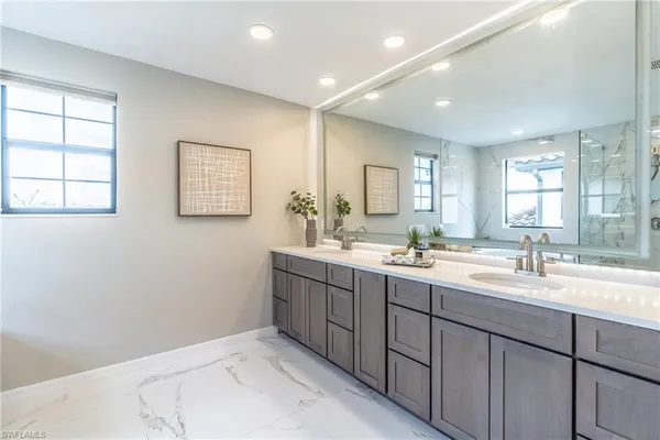 a bathroom with 2 sink tub and a mirror