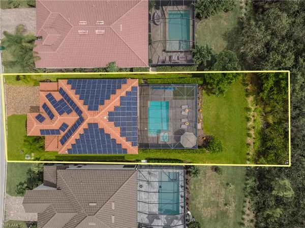 an aerial view of a house with a garden and swimming pool