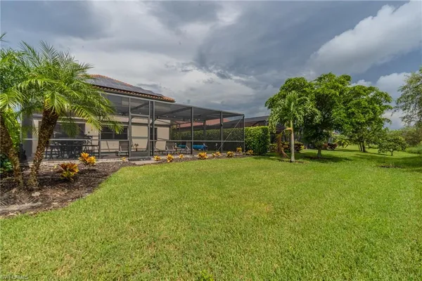 a view of yard with swimming pool and green space