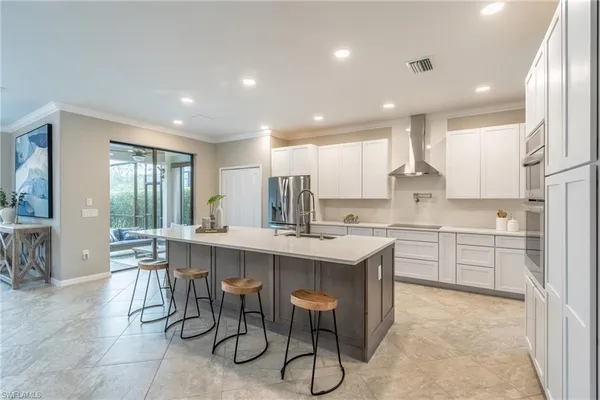 a kitchen with a sink and chairs