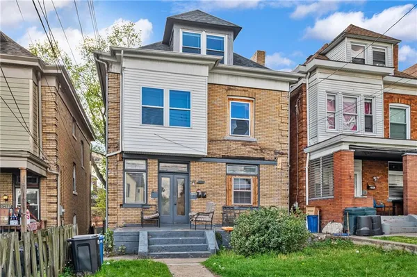a front view of a house with a yard