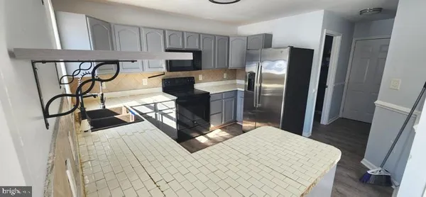 a kitchen with a stove and a refrigerator