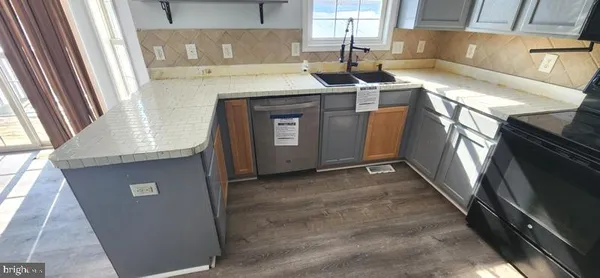 a kitchen with metallic refrigerator freezer and a sink