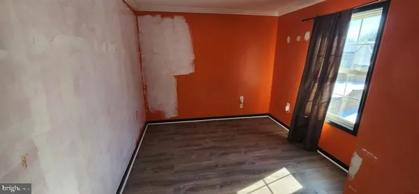 a view of a hallway with wooden floor and stairs