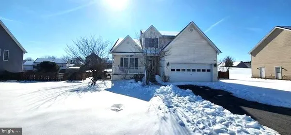 a view of a house with wooden fence
