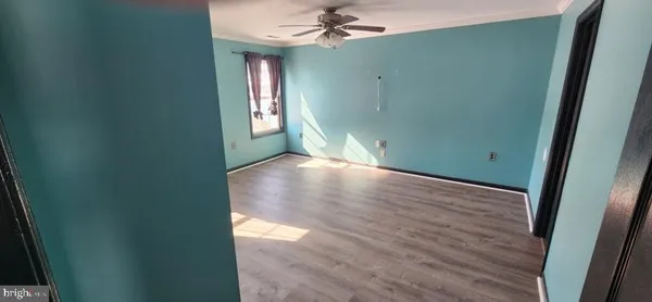 an empty room with closet and windows
