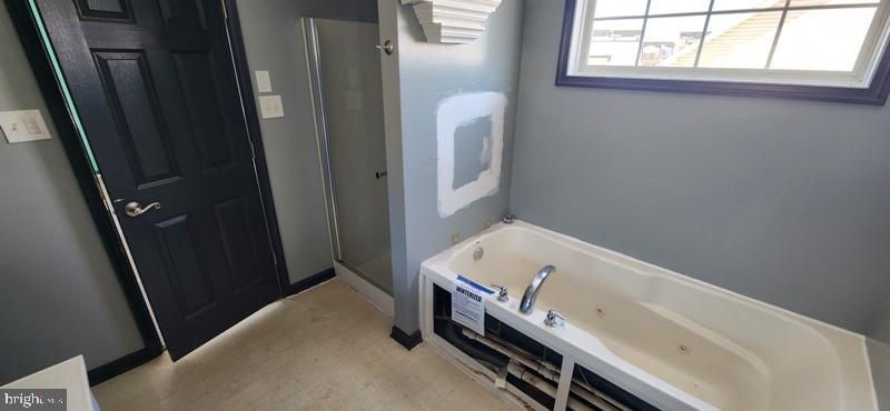 351 Thumper Drive Ranson, WV 25438 - Photo 25 of 44 a bathroom with a tub a sink and a window