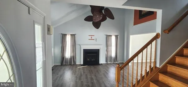 a view of an entryway with wooden floor and fireplace