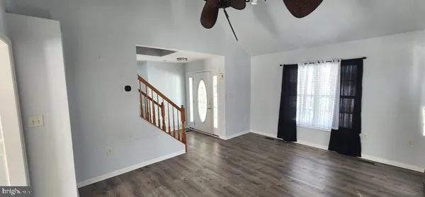 a view of an entryway with wooden floor