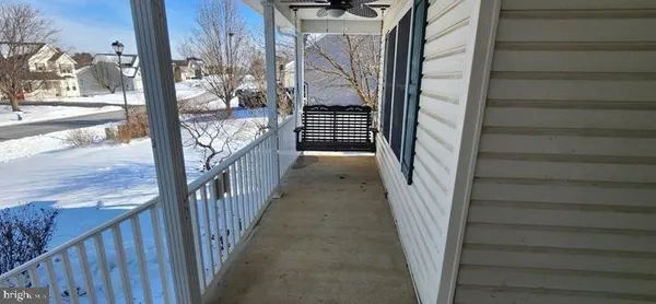 a view of a house with a yard covered in snow