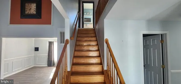 a view of staircase with white walls and a window