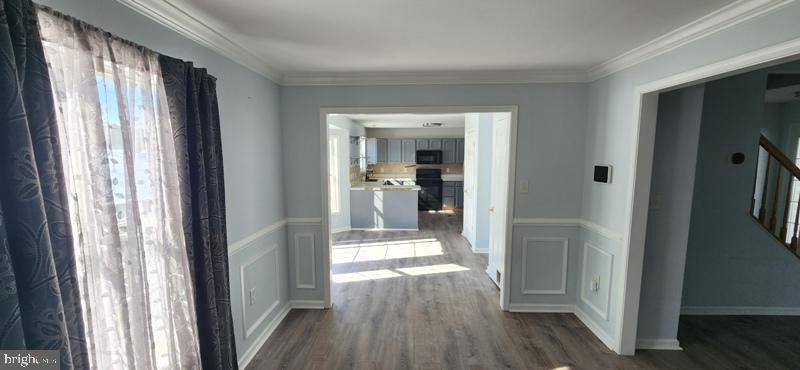 351 Thumper Drive Ranson, WV 25438 - Photo 8 of 44 a view of a hallway with wooden floor and windows