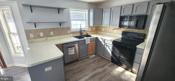 a kitchen with a sink appliances and cabinets