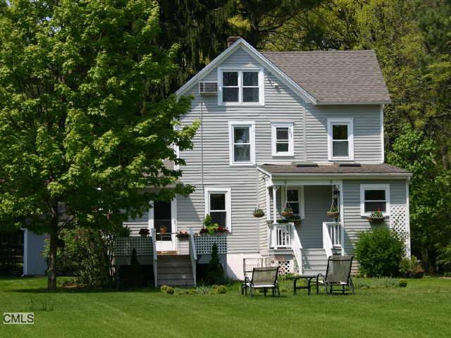 140 Bronson Road Fairfield, CT 06890 - Photo 1 of 1 a front view of a house with a yard