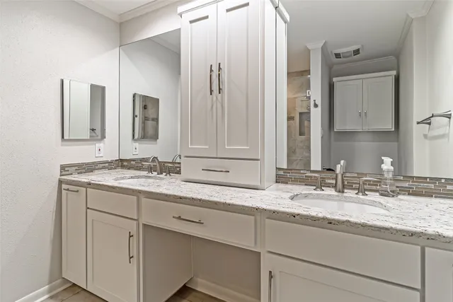 a bathroom with a granite countertop sink double and mirror