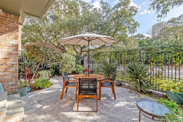 a backyard of a house with table and chairs