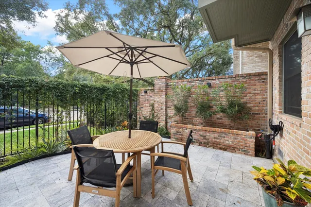 a view of a patio with a table chairs and a table