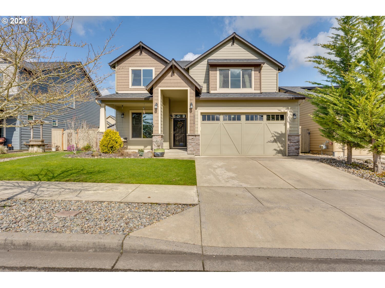 2314 South Wind River Way Ridgefield, WA 98642 - Photo 1 of 19 a front view of a house with a yard and garage