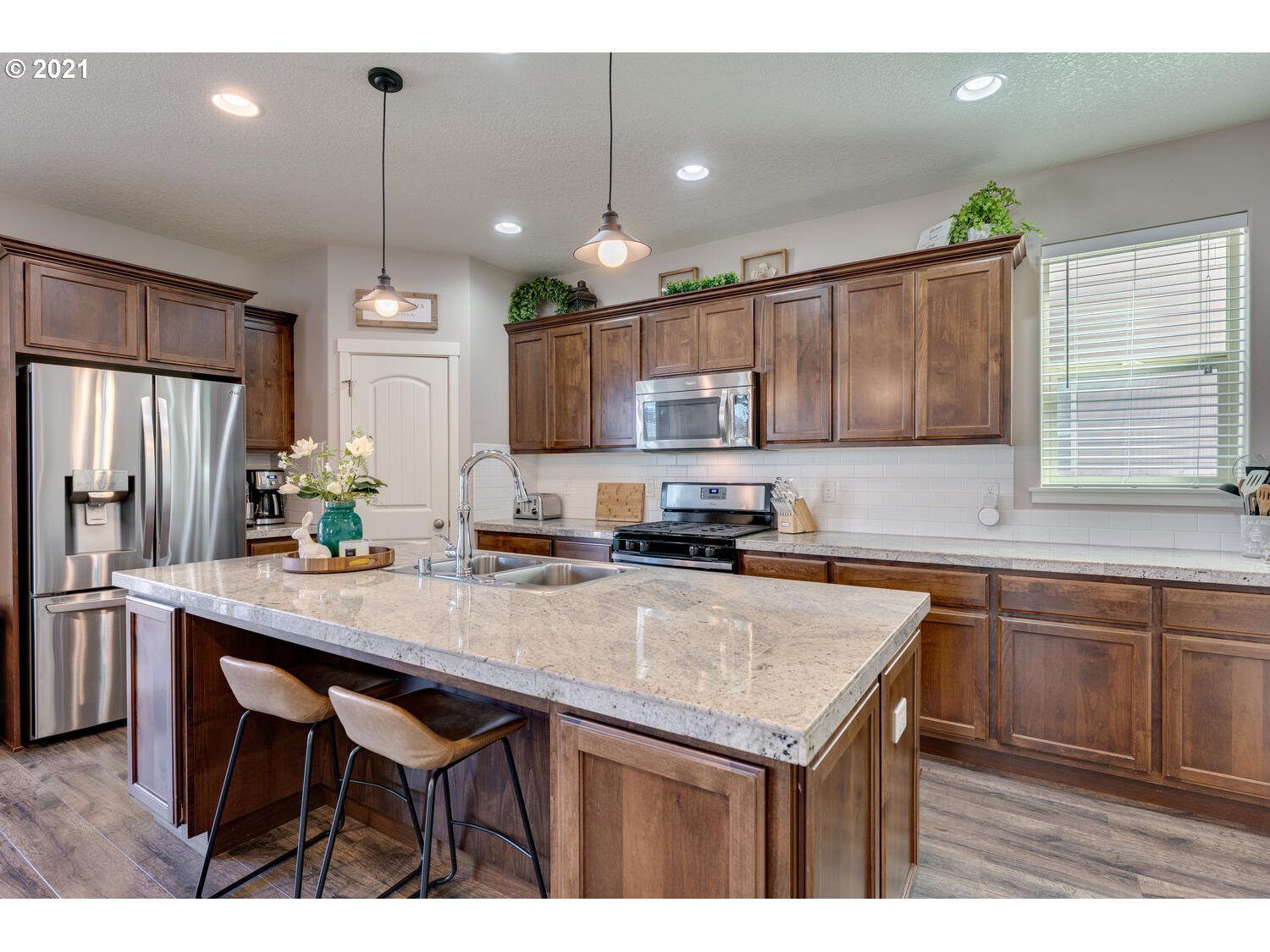 2314 South Wind River Way Ridgefield, WA 98642 - Photo 6 of 19 a kitchen with kitchen island a sink counter space appliances and cabinets