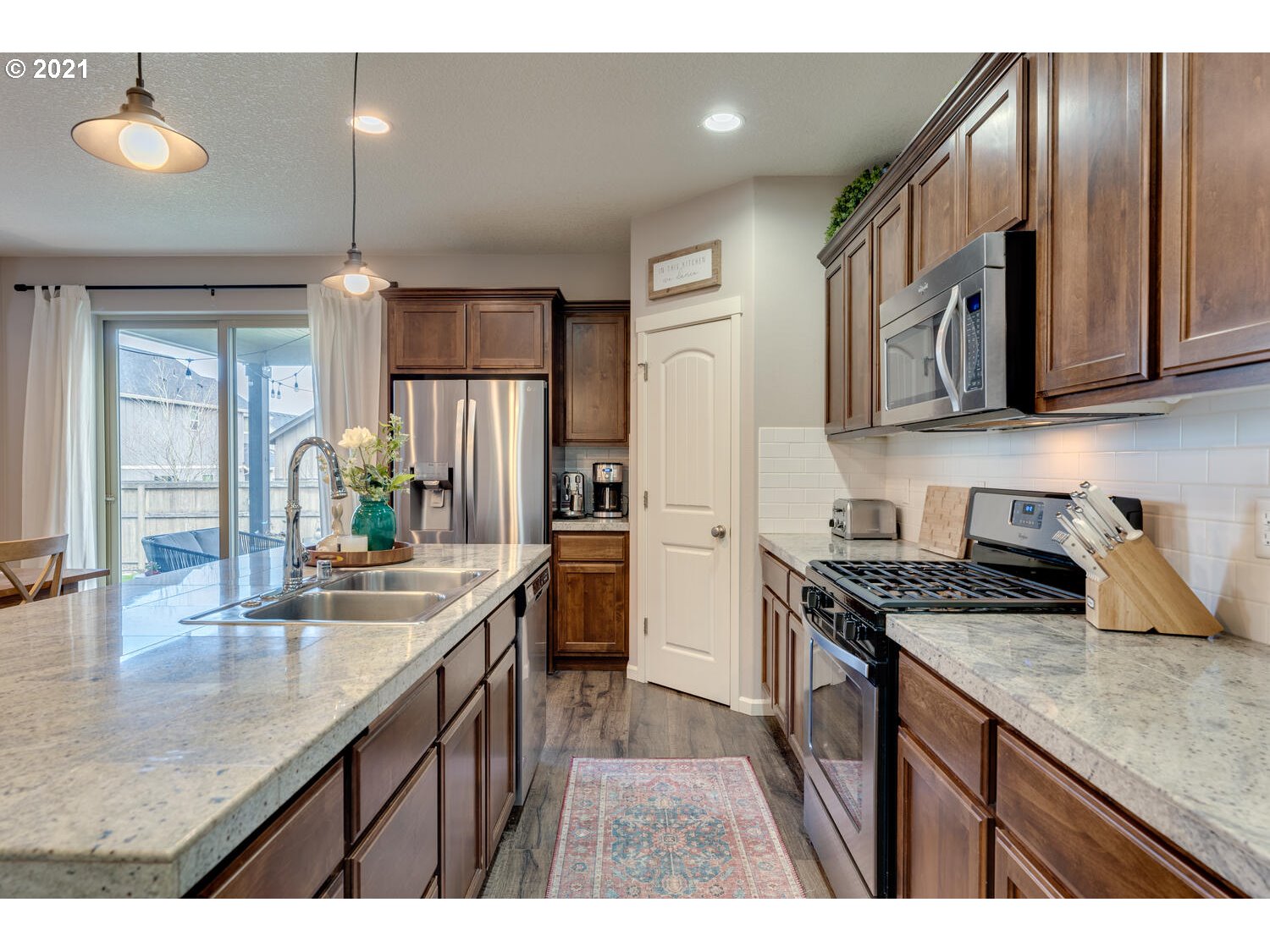 2314 South Wind River Way Ridgefield, WA 98642 - Photo 7 of 19 a kitchen with granite countertop stainless steel appliances a sink stove top oven and cabinets