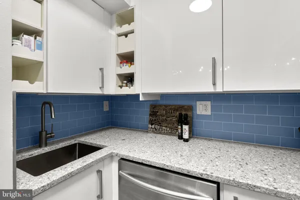 a kitchen with stainless steel appliances granite countertop a stove and a microwave